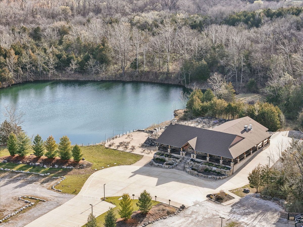 Aerial view of The Quarry wedding venue showing the lake, patios, and 26 acres of property in New Melle, MO